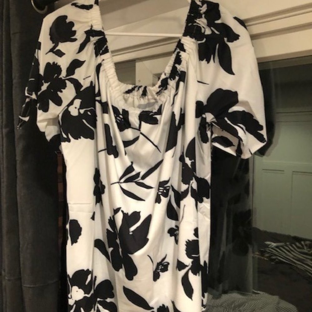 3 black & white short-sleeve shirts, 2 are stripes 1 is flowered/Hawaiian print